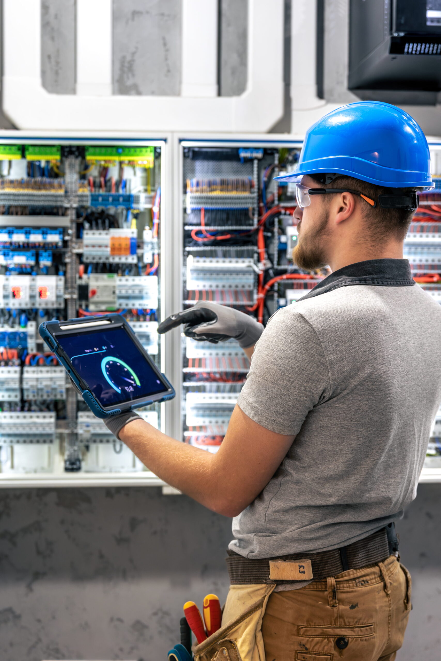 German-electrical-engineer-working-on-industrial-control-panel-scaled
